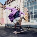Hombre haciendo un truco de equilibrio sobre el Giboard en el exterior