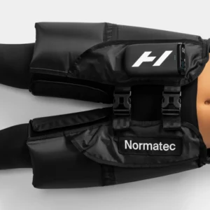 Vista cercana del Normatec Elite Cadera puesto en la cintura de una persona, mostrando las hebillas de ajuste, el logo Hyperice en la unidad de control y el texto Normatec en la banda frontal